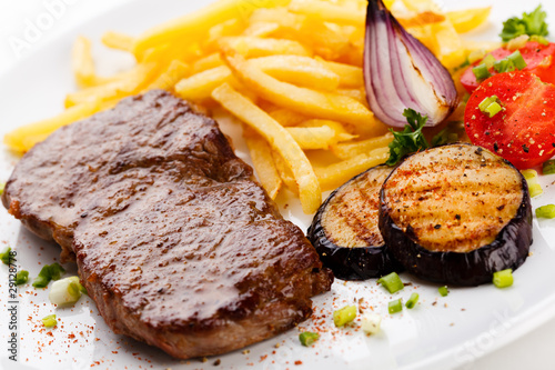 Steak with chips and vegetables