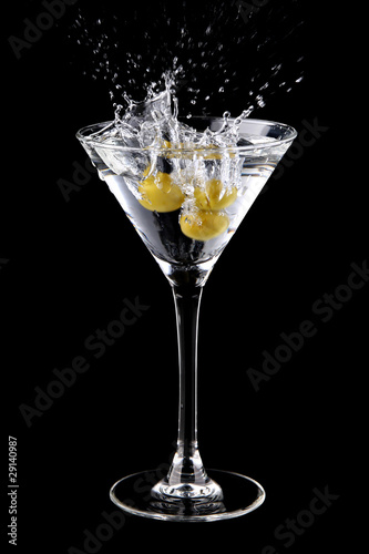 Martini cocktail with olives and splash