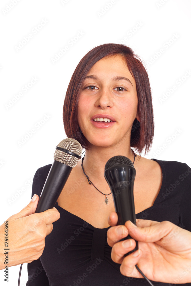 Young Woman Talking on the Microphone during Interview Young Woman Talking on the Microphone during Interview