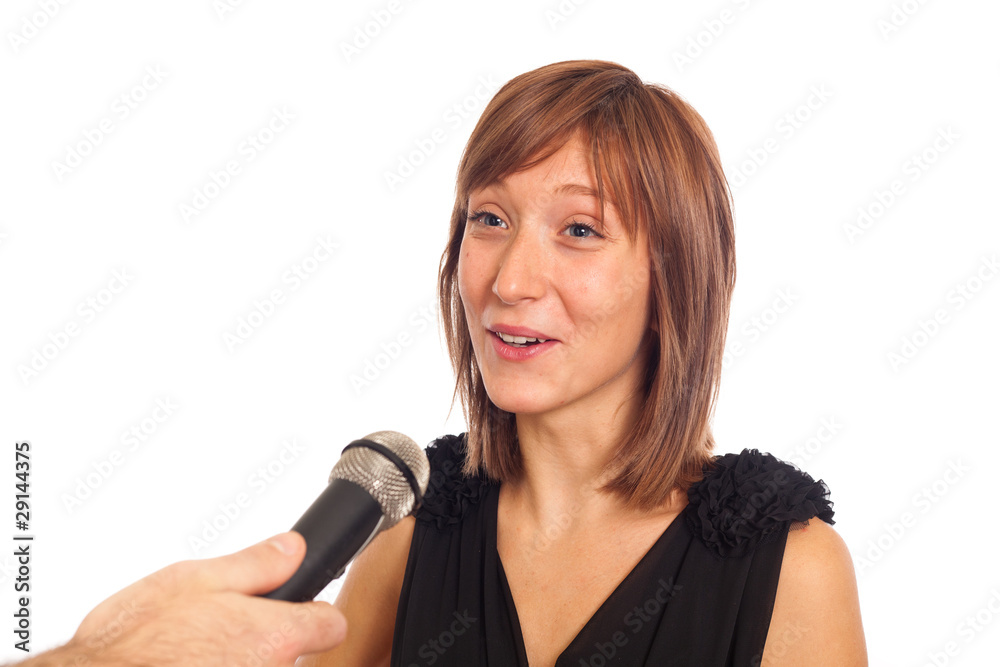 Young Woman Talking on the Microphone during Interview Young Woman Talking on the Microphone during Interview