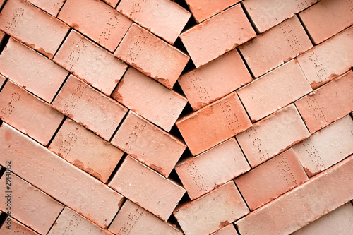 Background of many red bricks for cinstruction in pallet