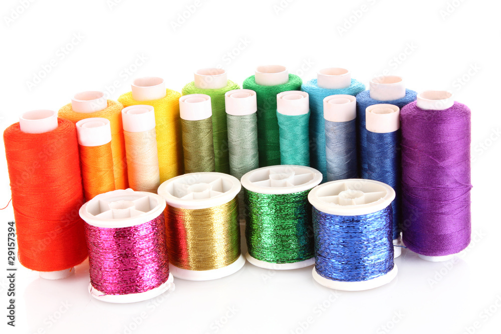 Semicircle of many-coloured bobbins of thread isolated on white Semicircle of many-coloured bobbins of thread isolated on white