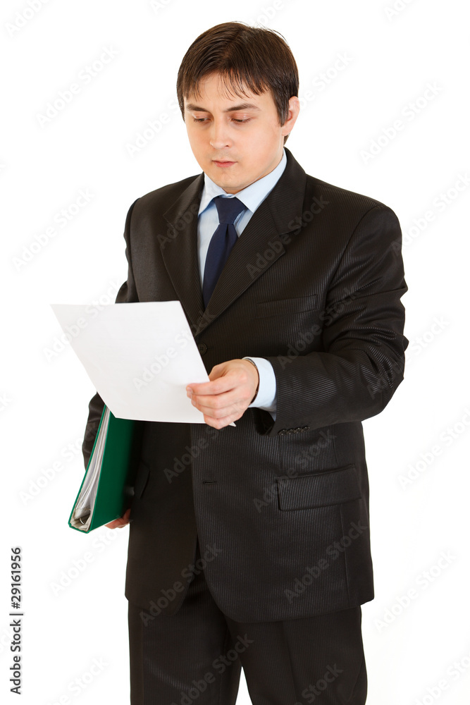 Serious businessman with folder in hand exploring document Serious businessman with folder in hand exploring document