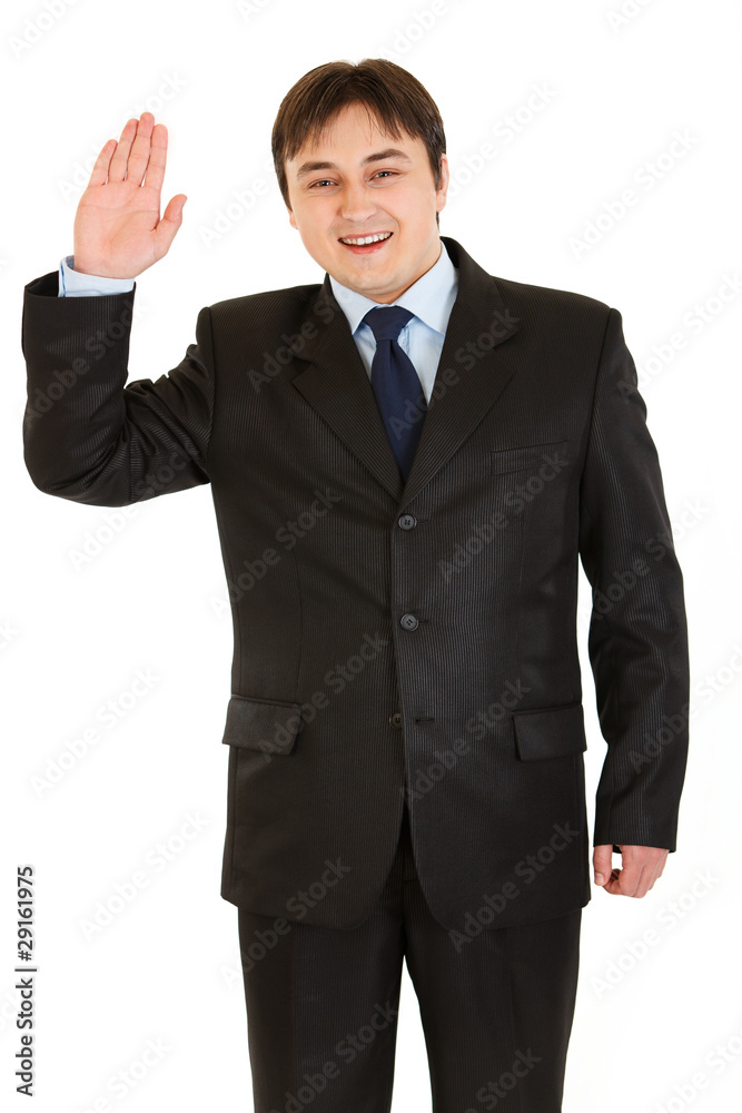 Friendly modern businessman showing salutation gesture Friendly modern businessman showing salutation gesture
