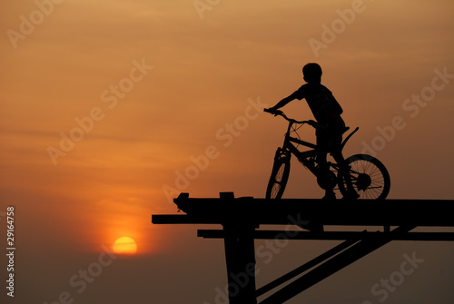 Fototapeta Naklejka Na Ścianę i Meble -  A boy sitting on bicycle 2