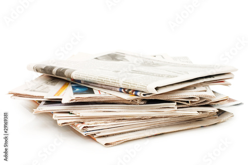 Various newspapers over white background