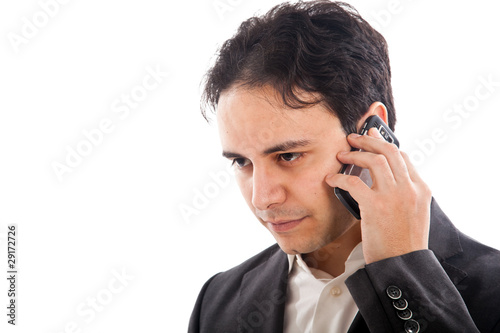 Businessman talking at the phone isolated on white