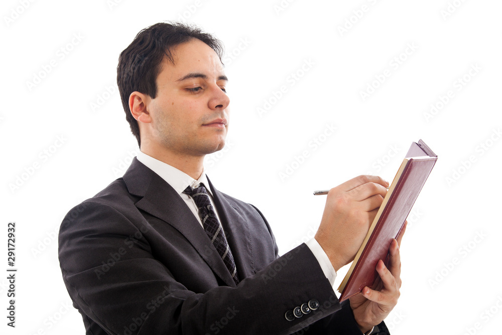 Businessman in black suit writing on agenda isolated on white Businessman in black suit writing on agenda isolated on white
