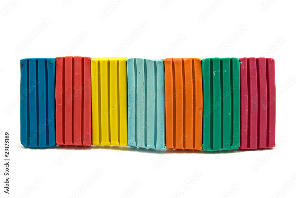 row of colorful plasticine on white background row of colorful plasticine on white background
