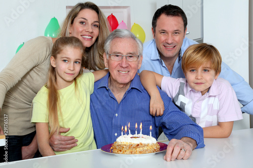 Family celebrating grandfather s birthday