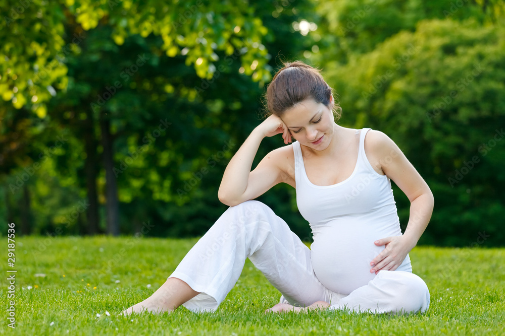 Beautiful pregnant woman relaxing in the park Beautiful pregnant woman relaxing in the park