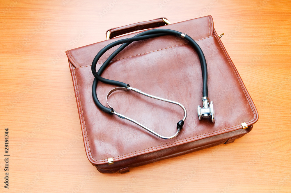 Doctor's case with stethoscope against wooden background