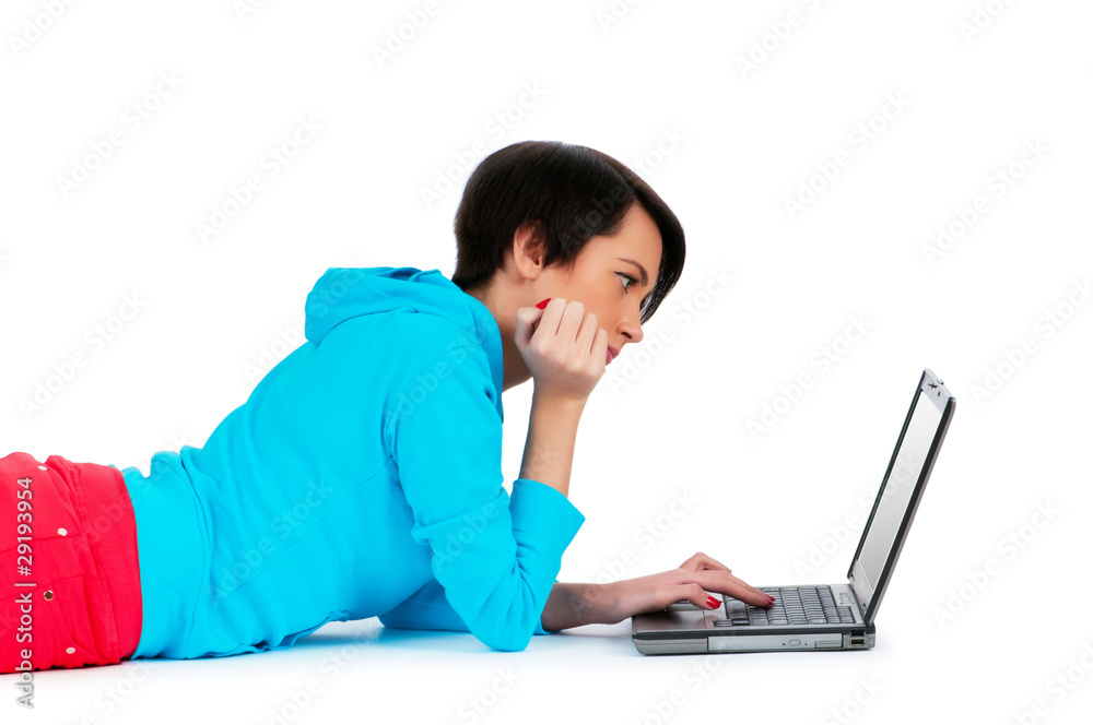 Young girl working on laptop isolated on white Young girl working on laptop isolated on white