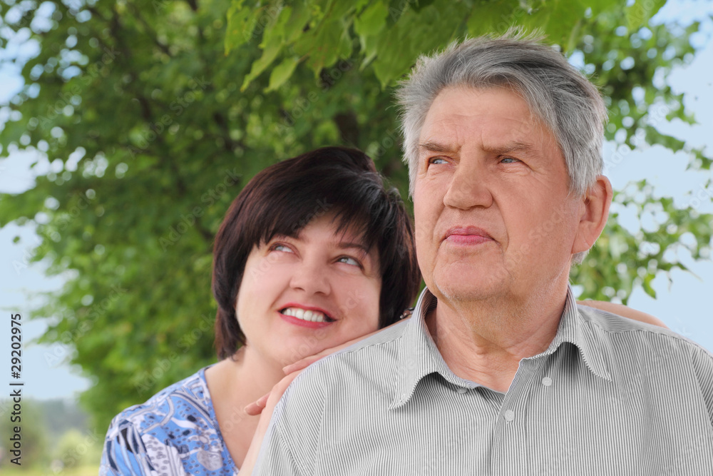 portrait of old senior, his adult daughter leans on his shoulder portrait of old senior, his adult daughter leans on his shoulder