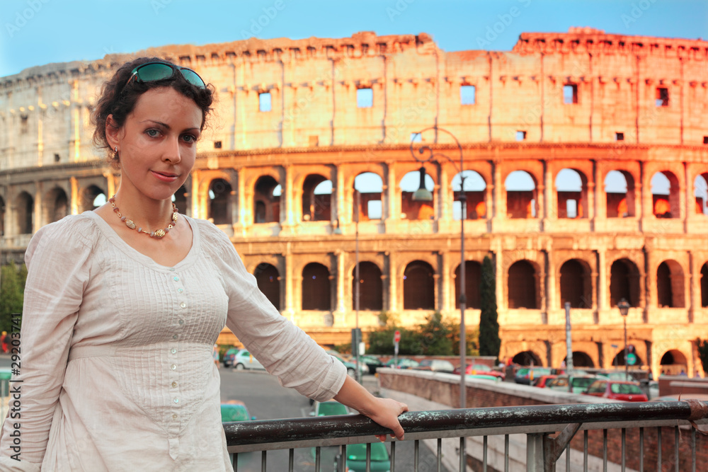 woman in white wear standing on bridge near Colosseum
