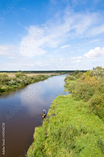 Fototapeta Naklejka Na Ścianę i Meble -  Small blue river surround the green banks. Belarus.
