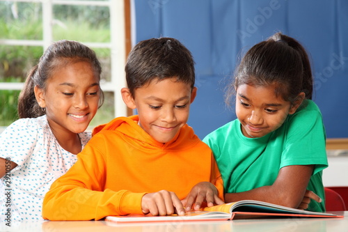 Primary school children in class reading learning