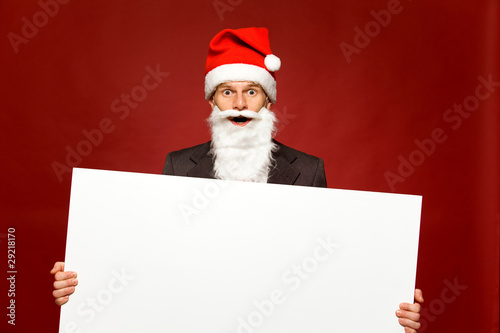 Santa holding blank poster