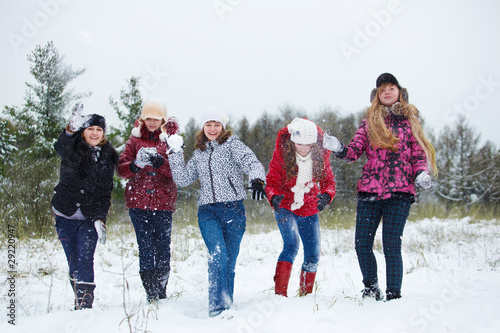 Teenagers playing snowballs