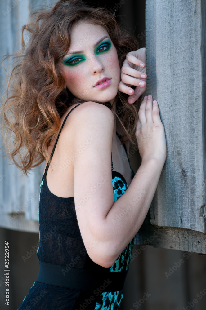Fototapeta premium Fashion woman with green make-up at rural location