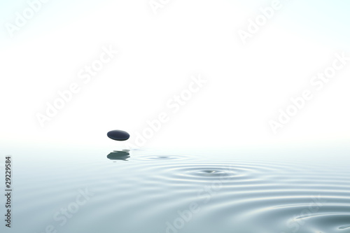 Zen stone thrown on the water photo