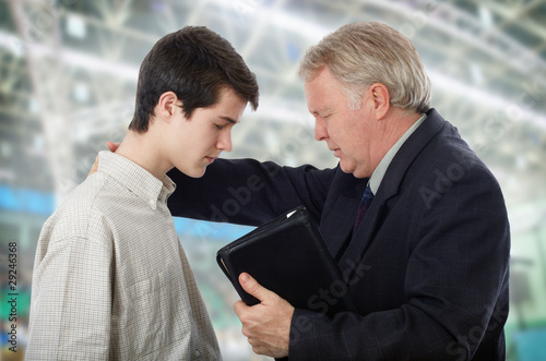 Preacher leading a young man in prayer to receive Lord Jesus