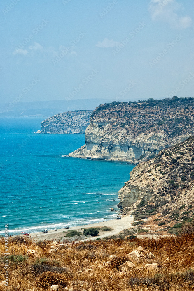 Kourion coast with blue sea and sky with clouds.