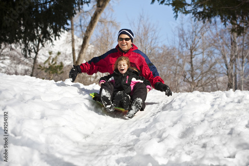 Konstfotografi Family having fun together snow sledding