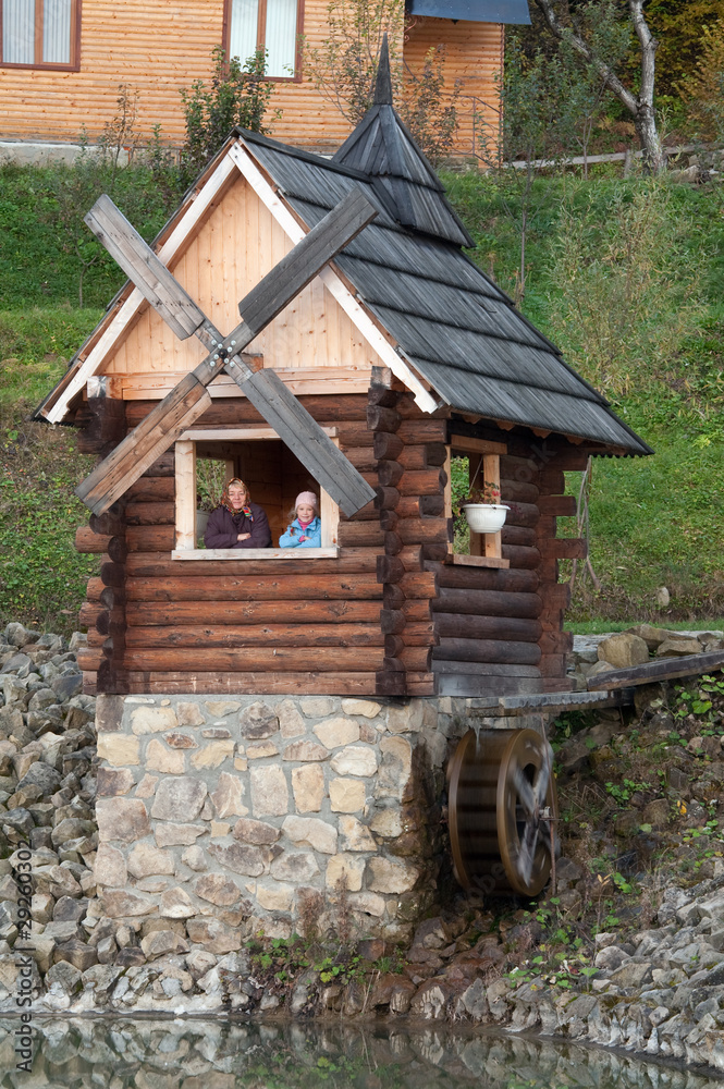 Grandmother and granddaughter in wooden house