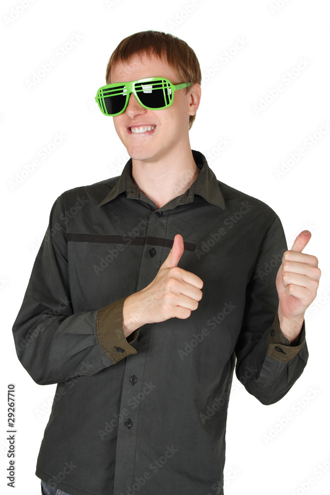 young man in modern club sunglasses grinning and making thumbs u young man in modern club sunglasses grinning and making thumbs u