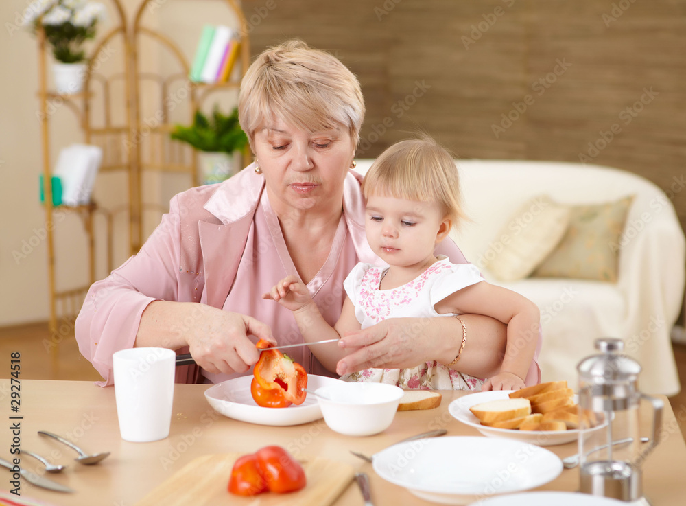 grandmother feeding granddaughter at home grandmother feeding granddaughter at home
