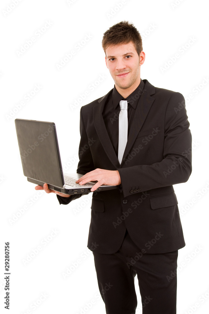Portrait of a young business man standing with laptop against wh Portrait of a young business man standing with laptop against wh