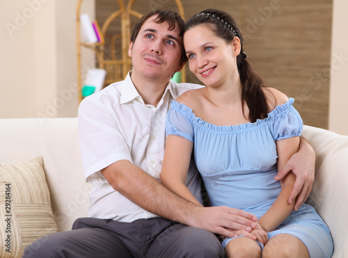 young couple at home on a sofa