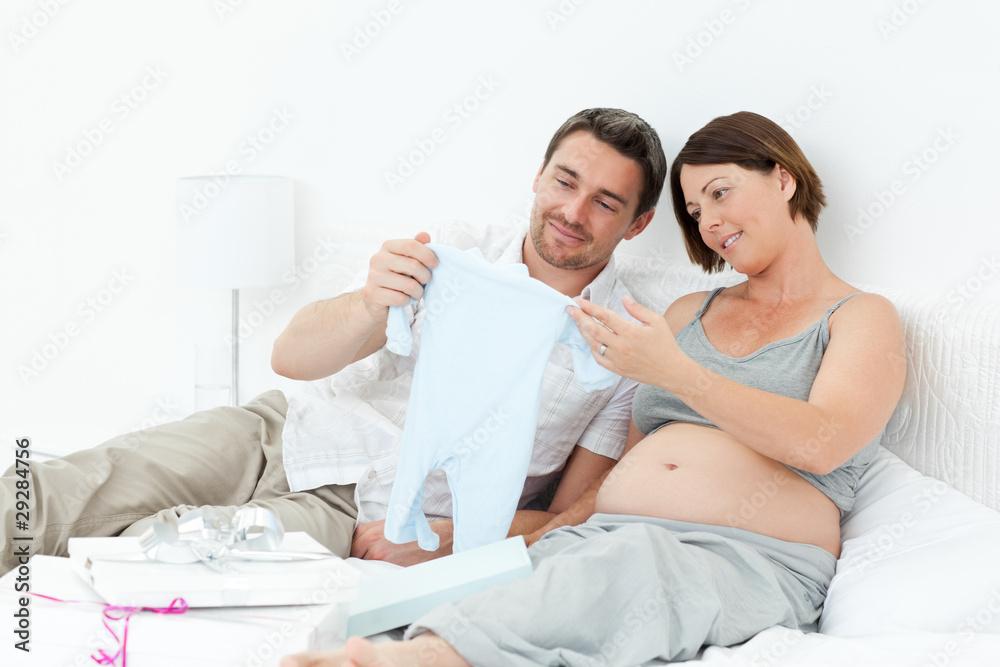 Young futur parents with chlidrens clothes Young futur parents with chlidrens clothes