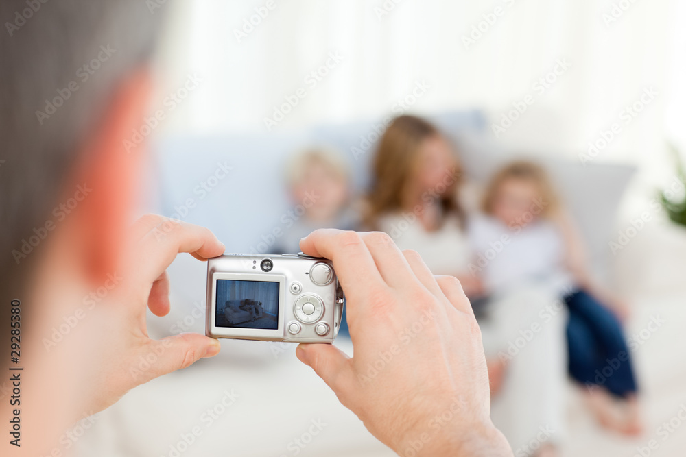 Man taking a photo of his family Man taking a photo of his family
