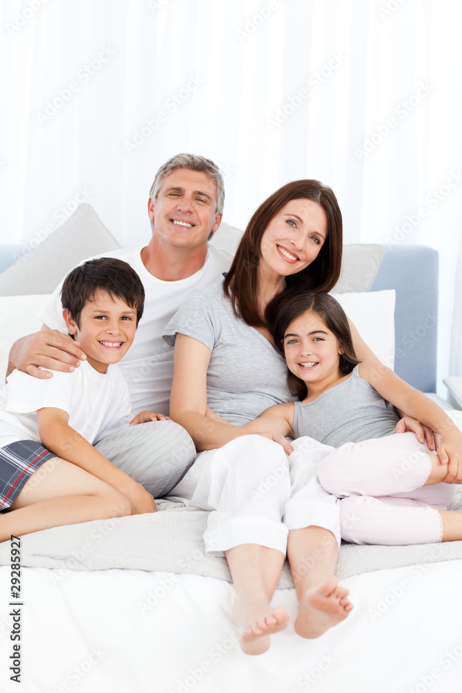 Family lying down on their bed Family lying down on their bed