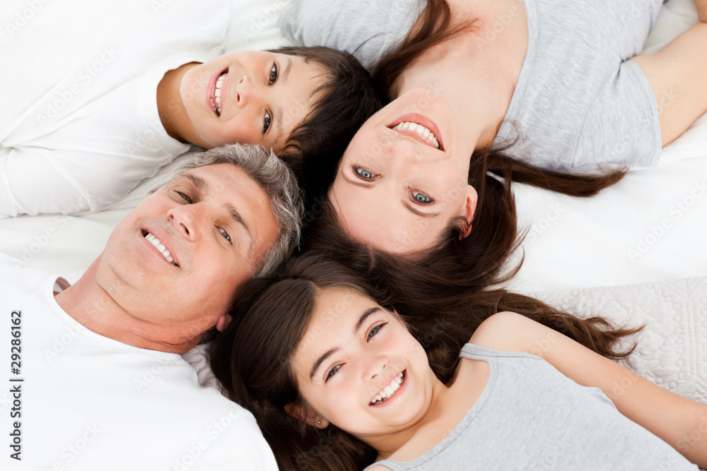 Family lying down on their bed Family lying down on their bed