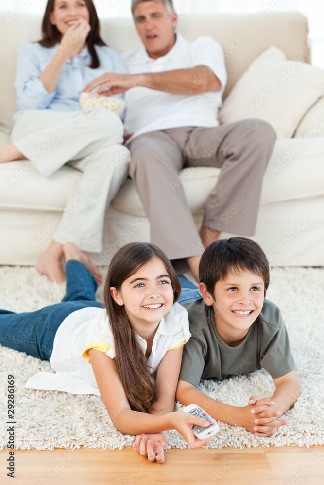 Family watching tv in the living room