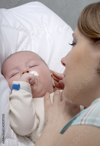 Young mother with cute little son. Isolated over white