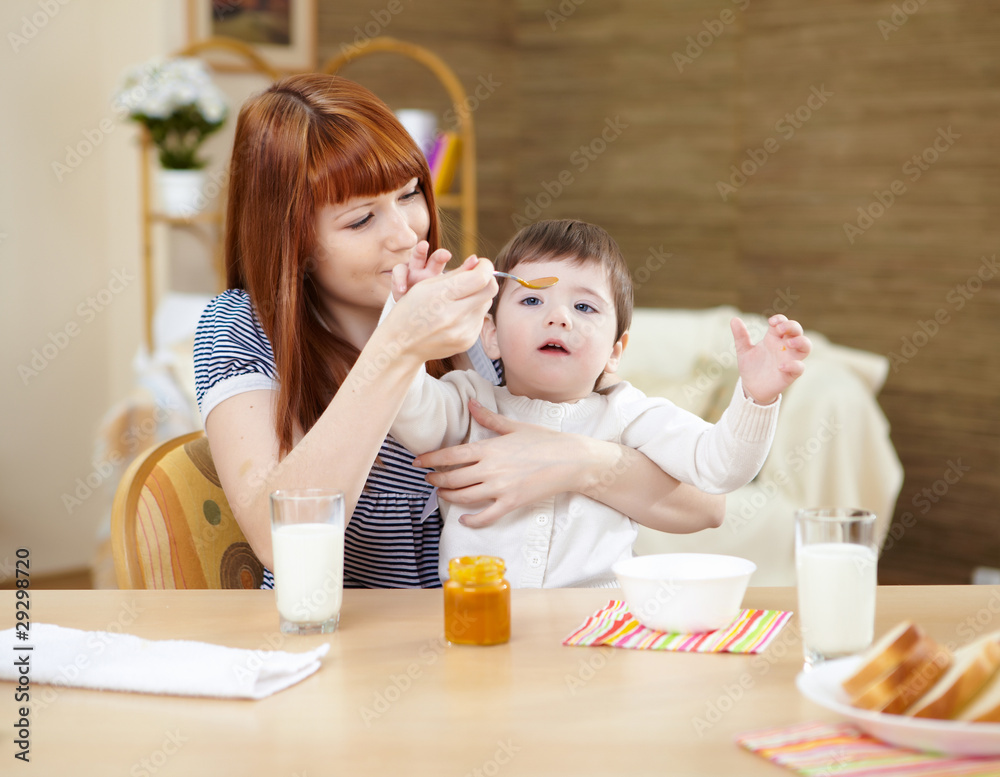 mother feeding a baby at home