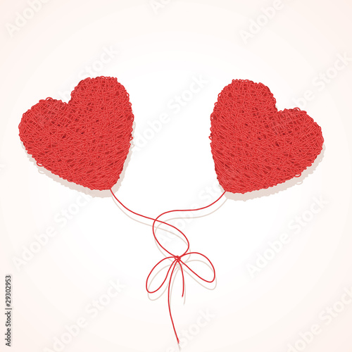 Two knotted balls of threads in form of heart