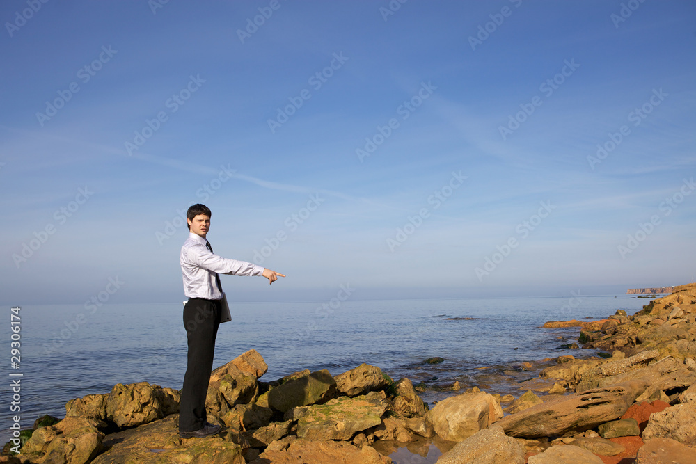 Man near sea with laptop