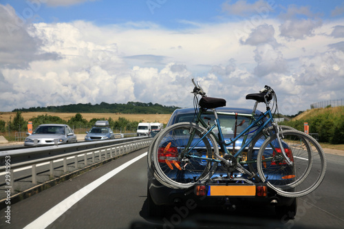 Car with bicycles on the scenic road during traveling