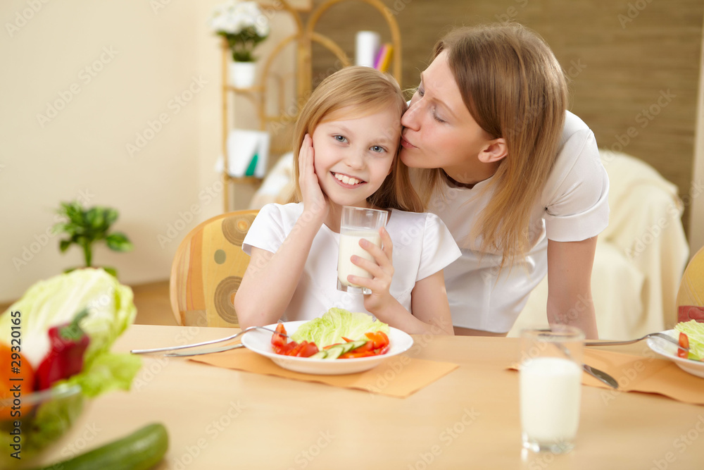 mother with teenager daughter having meal at home