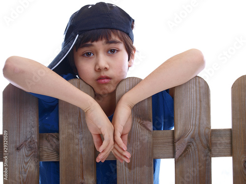 child looking over a fence