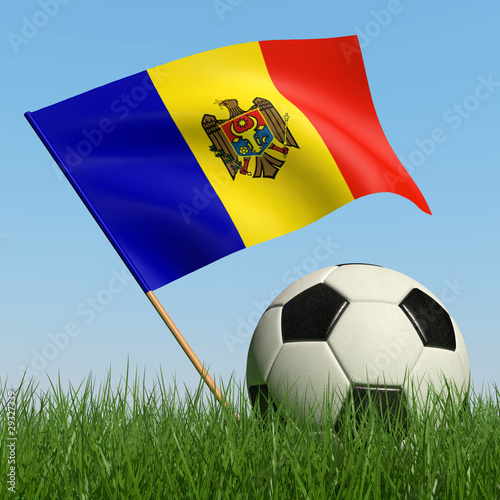 Soccer ball in the grass and flag of Moldova.