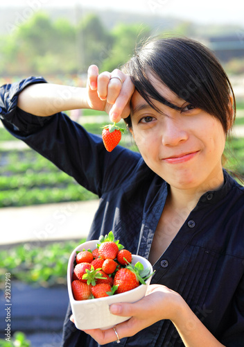 happy woman pick strawberry