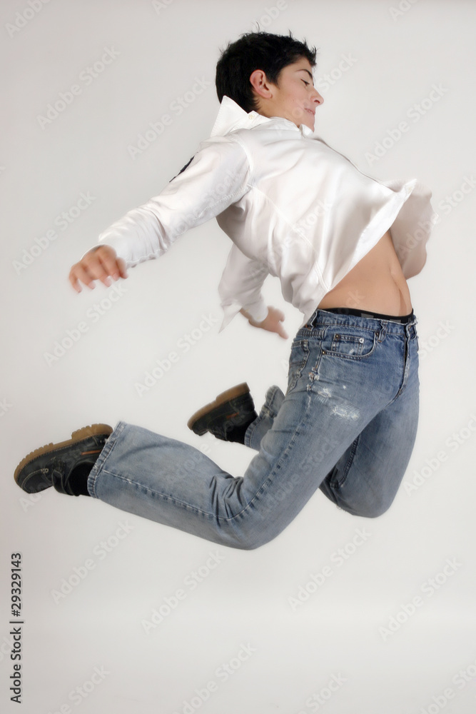young teenage boy jumping jeans shirt Stock Photo Adobe Stock