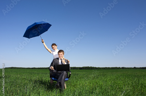 Businessman finding protection outside in the field