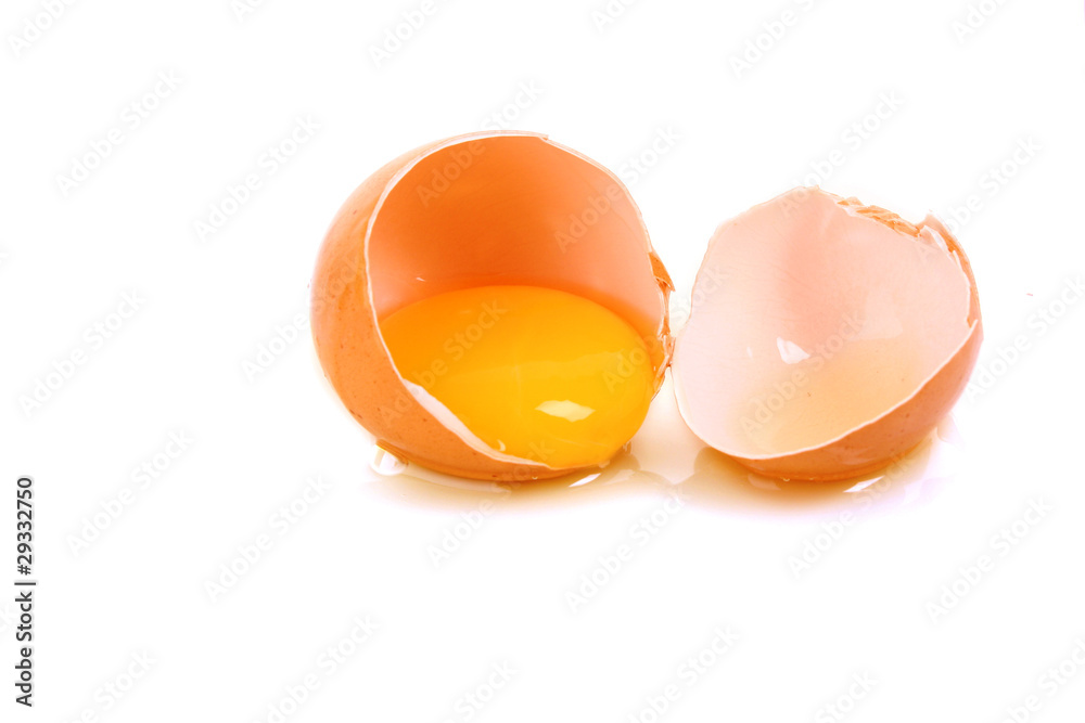 One cracked hen's egg isolated on white